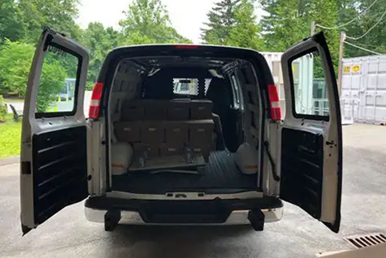 van with a set of boxes loaded inside of it