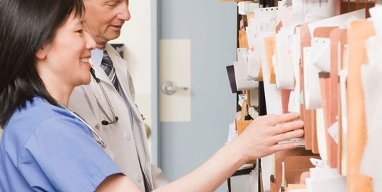 Doctor and nurse going through medical charts